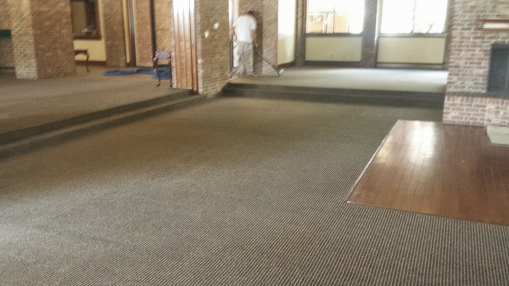 Large commercial carpeted room after cleaning