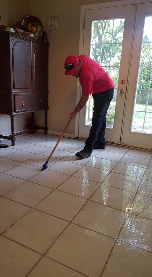 Technician cleaning tile floor